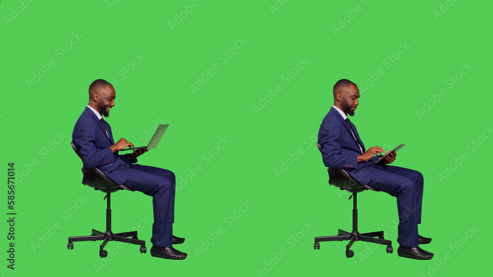 Young entrepreneur working with laptop and tablet wearing business suit on camera, browsing on online website for information. Startup manager using digital device and portable pc. Young entrepreneur working with laptop and tablet wearing business suit on camera, browsing on online website for information. Startup manager using digital device and portable pc.