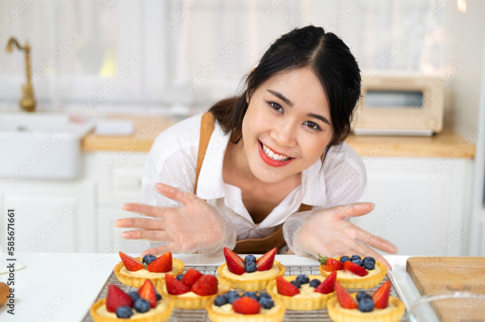 Freshly baked tart with blueberries strawberry fresh fruit kitchen for dessert.Young beautiful woman is baking in kitchen , bakery and coffee shop business.  bakery and coffee shop business.