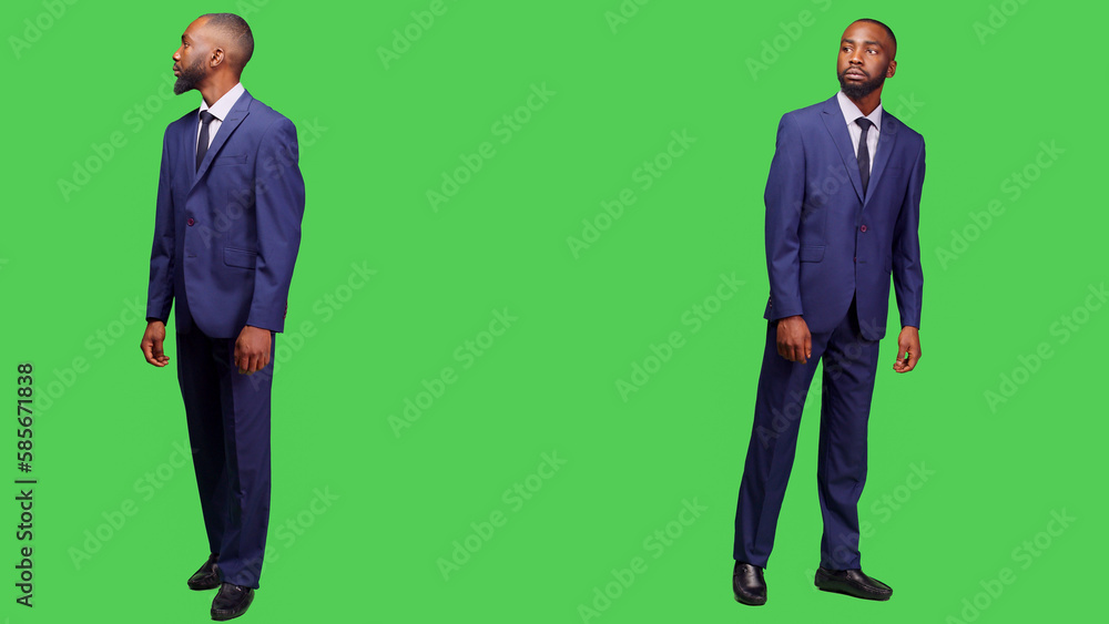 African american businessman looking around in studio, waiting for something and wearing office suit. Formal startup employee acting confident posing over full body greenscreen backdrop. African american businessman looking around in studio, waiting for something and wearing office suit. Formal startup employee acting confident posing over full body greenscreen backdrop.