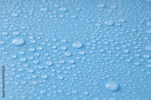 Blue background with water drops, close up