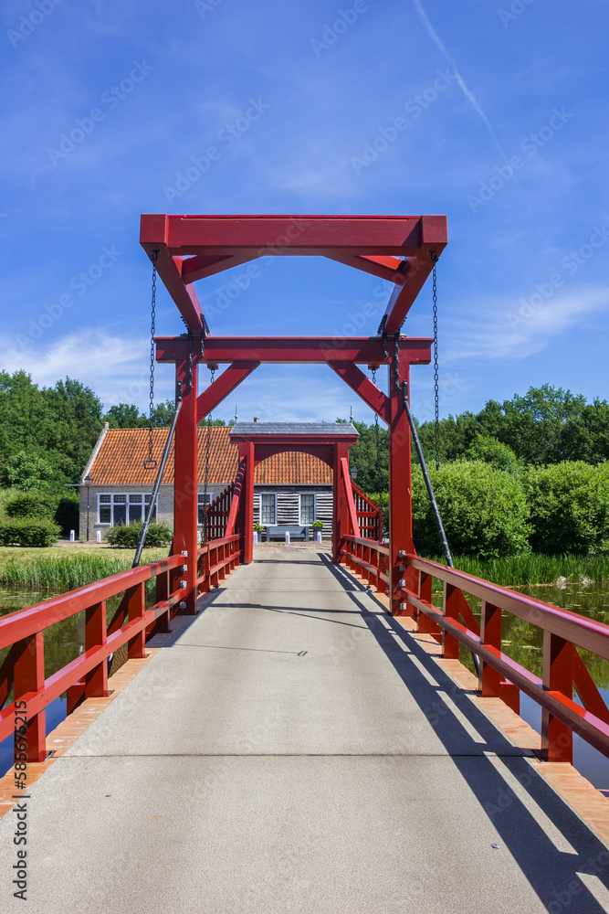 Red wooden bridge leading to the historic town of Bourtange, Netherlands Red wooden bridge leading to the historic town of Bourtange, Netherlands
