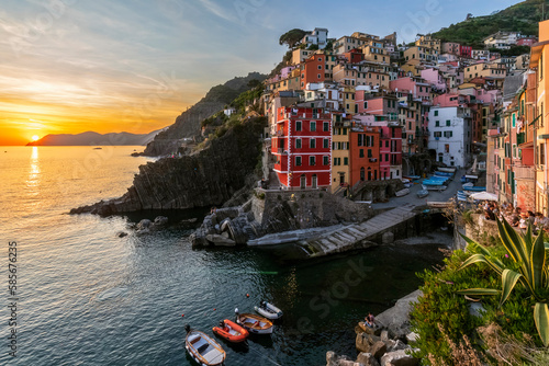 Italy, Liguria, Riomaggiore, Edge of coastal village along Cinque Terre at sunset photo