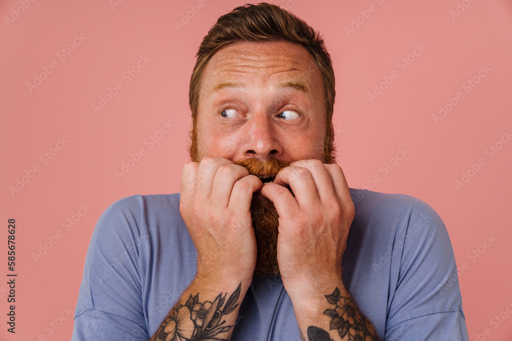 Ginger scared man with beard expressing surprise at camera Ginger scared man with beard expressing surprise at camera