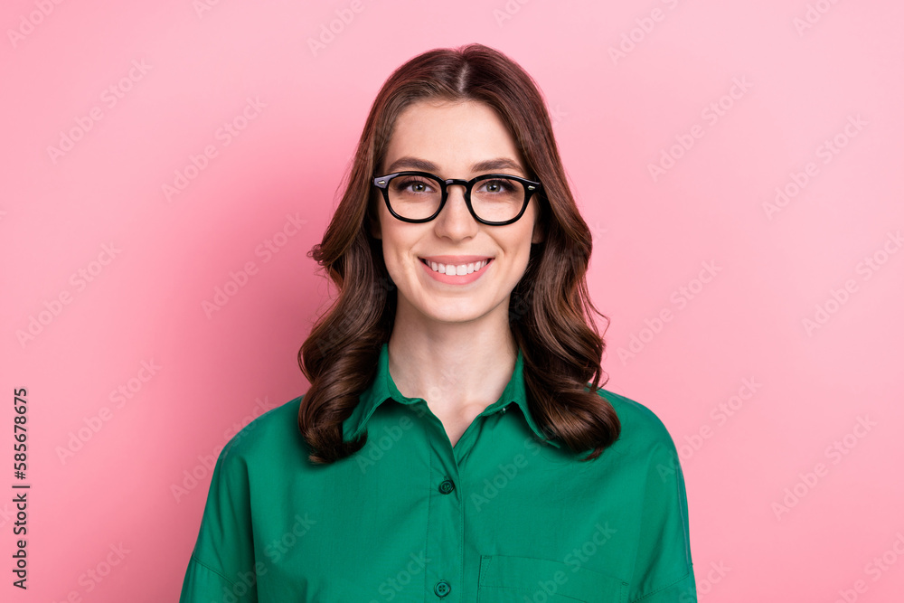 Photo of gorgeous clever cute friendly woman with wavy hairdo dressed green shirt glasses toothy smiling isolated on pink background