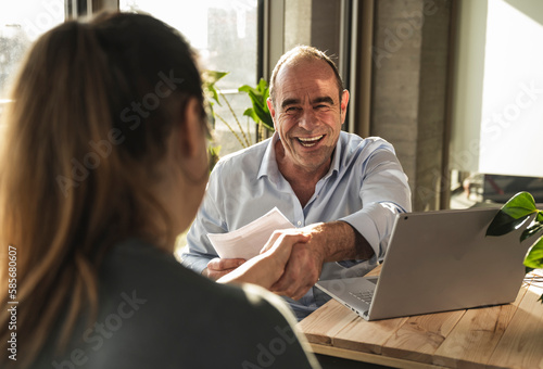 Wallpaper Mural Happy mature businessman doing handshake with colleague in office Torontodigital.ca