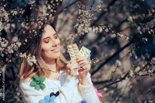 Happy Woman Holding Medicine Tablets During Spring Season. Cheerful girl holding antihistamine treatment against allergies  
 photo