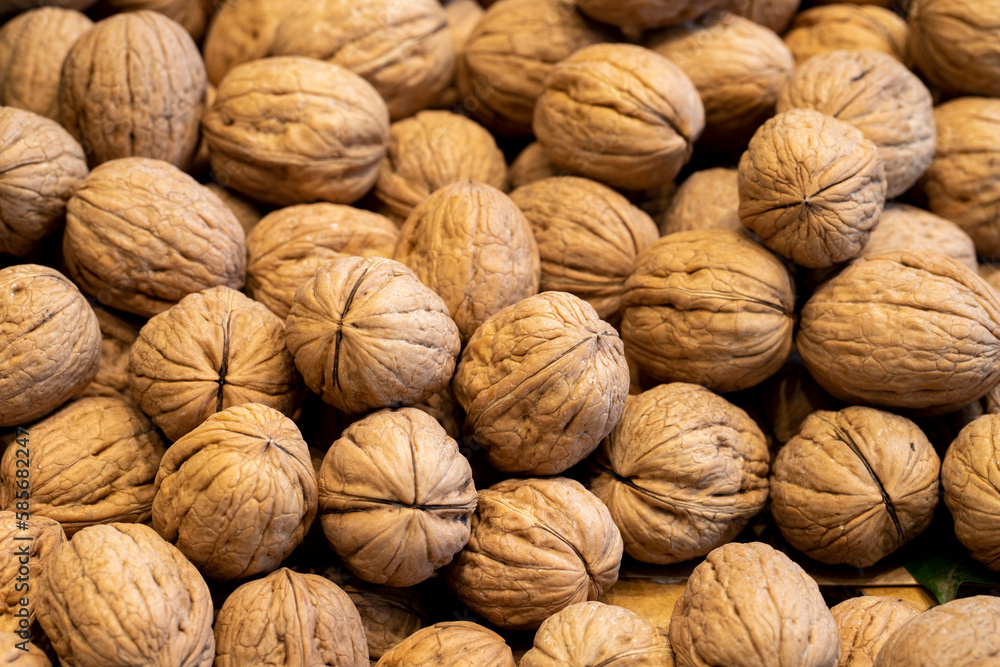 Shelled walnuts. Pile of unshelled walnuts in daylight. Walnut background. Flat lay. Banner Shelled walnuts. Pile of unshelled walnuts in daylight. Walnut background. Flat lay. Banner