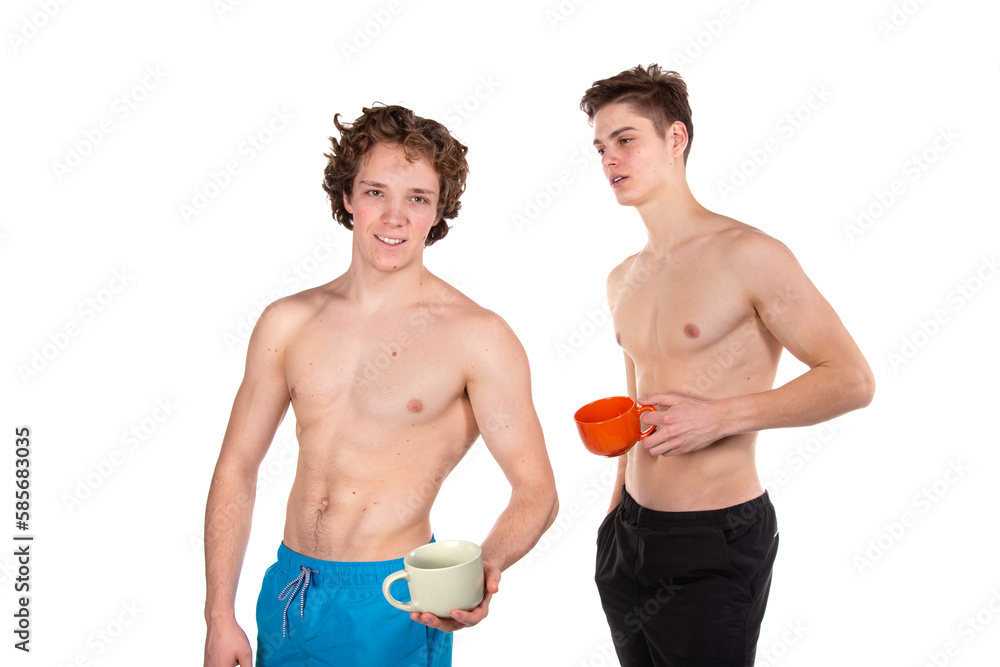 Two young attractive guys are drinking coffee. White background. Two young attractive guys are drinking coffee. White background.
