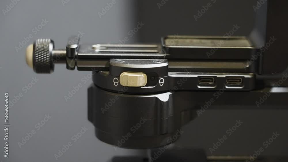 Unlocking the arm of a gimbal to balance a camera. Unlocking the arm of a gimbal to balance a camera.