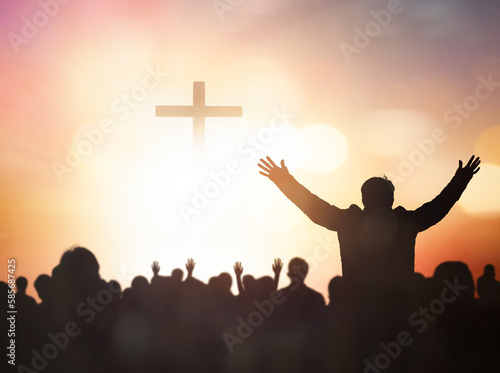 Easter and Good Friday concept,Silhouette human raising hand to praying God on blurred cross sunset background