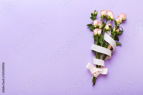 Bouquet of pinkand white roses on colored background. Mother's day, Valentines Day, Birthday celebration concept. Greeting card. Copy space for text, top view photo