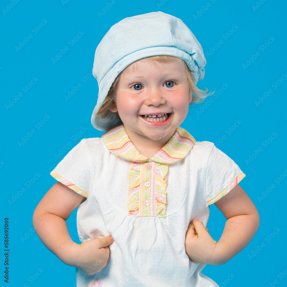 Portrait of beautiful little girl against blue background Portrait of beautiful little girl against blue background