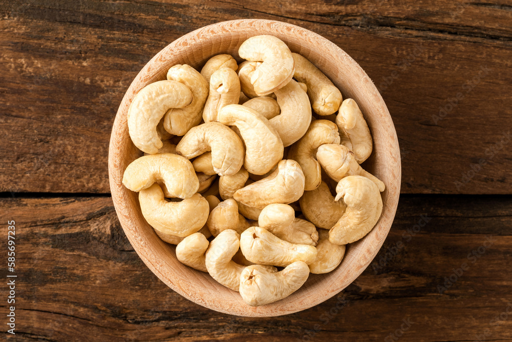 Fresh cashews in bowl on wooden table. Healthy snacks Fresh cashews in bowl on wooden table. Healthy snacks