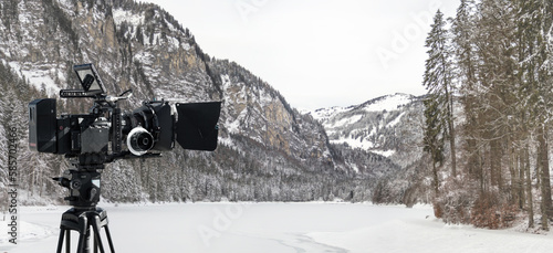 Wallpaper Mural Digital film camera filming winter in the mountains near a frost lake. Wide panoramic view for tv show production banner or documentaries background Torontodigital.ca
