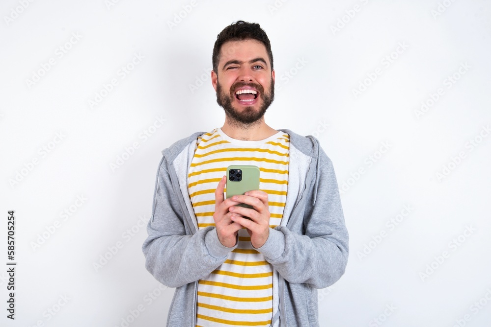 Young caucasian mán wearing trendy clothes over white background taking a selfie celebrating success Young caucasian mán wearing trendy clothes over white background taking a selfie celebrating success