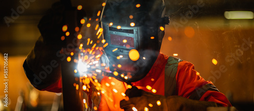 Panoramic workers wearing industrial uniforms using electric arc welding machine to weld steel at factory. Metalwork manufacturing and construction maintenance service by manual skill labor concept.