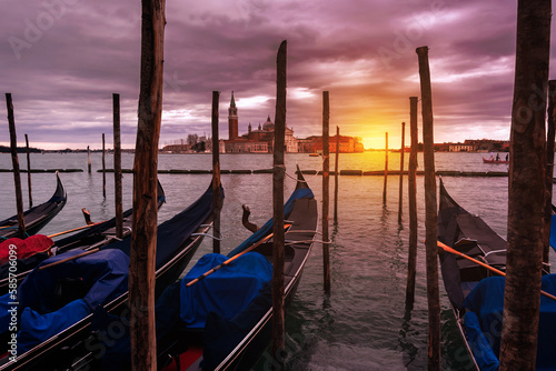 Gondolas in Venice on sunset next to San Marco square. Famous landmark in Italy © Maresol