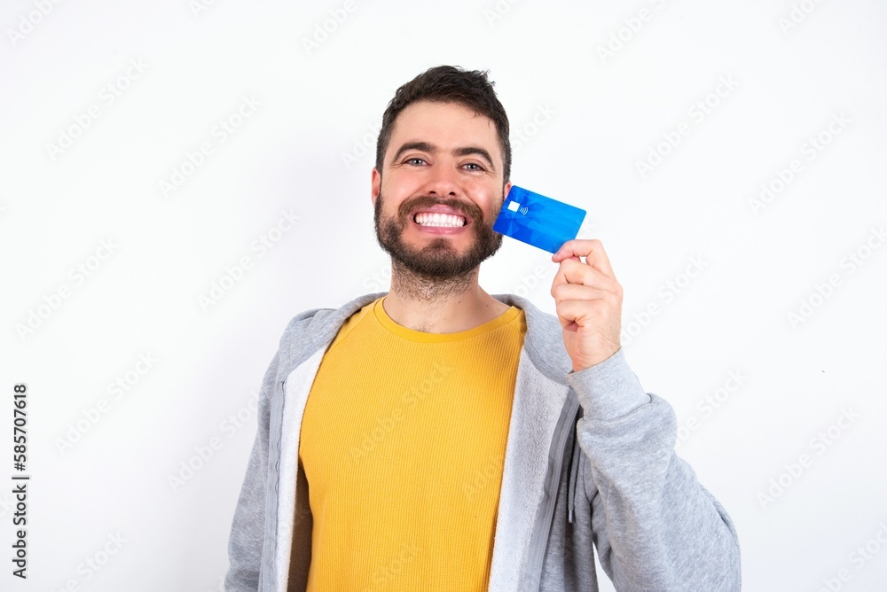 Close up photo of optimistic Young caucasian mán wearing trendy clothes over white background hold card Close up photo of optimistic Young caucasian mán wearing trendy clothes over white background hold card