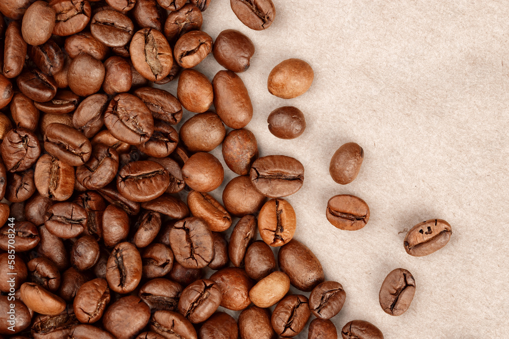 roasted whole arabica coffee beans, scattered on paper, isolated roasted whole arabica coffee beans, scattered on paper, isolated