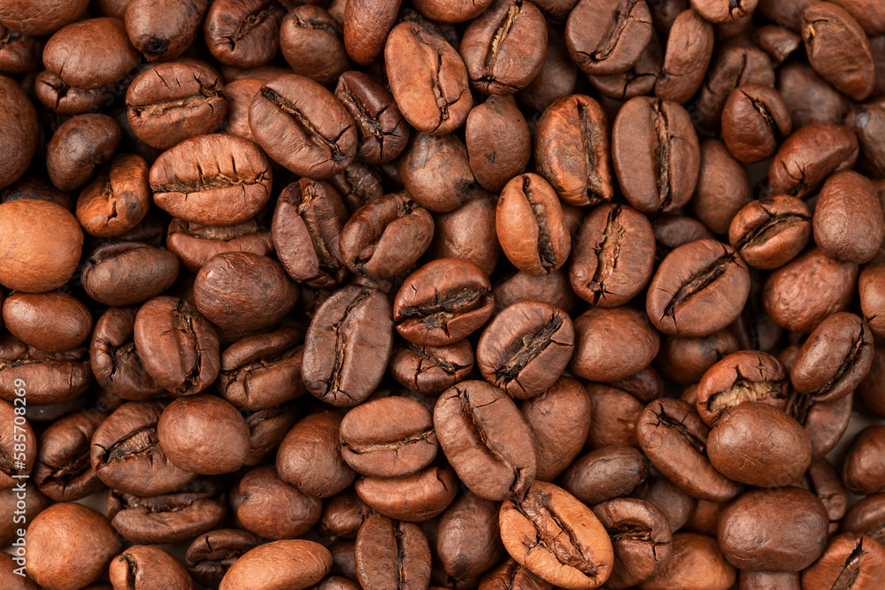 roasted whole arabica coffee beans, scattered on paper, isolated roasted whole arabica coffee beans, scattered on paper, isolated