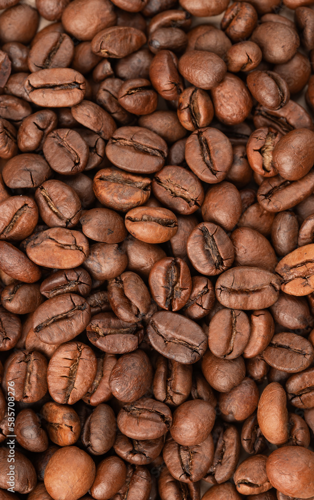 roasted whole arabica coffee beans, scattered on paper, isolated roasted whole arabica coffee beans, scattered on paper, isolated