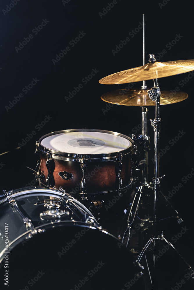 Snare drum on a blurred dark background, part of a drum kit. Snare drum on a blurred dark background, part of a drum kit.