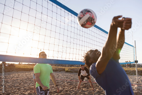 Friends playing volleyball on beach