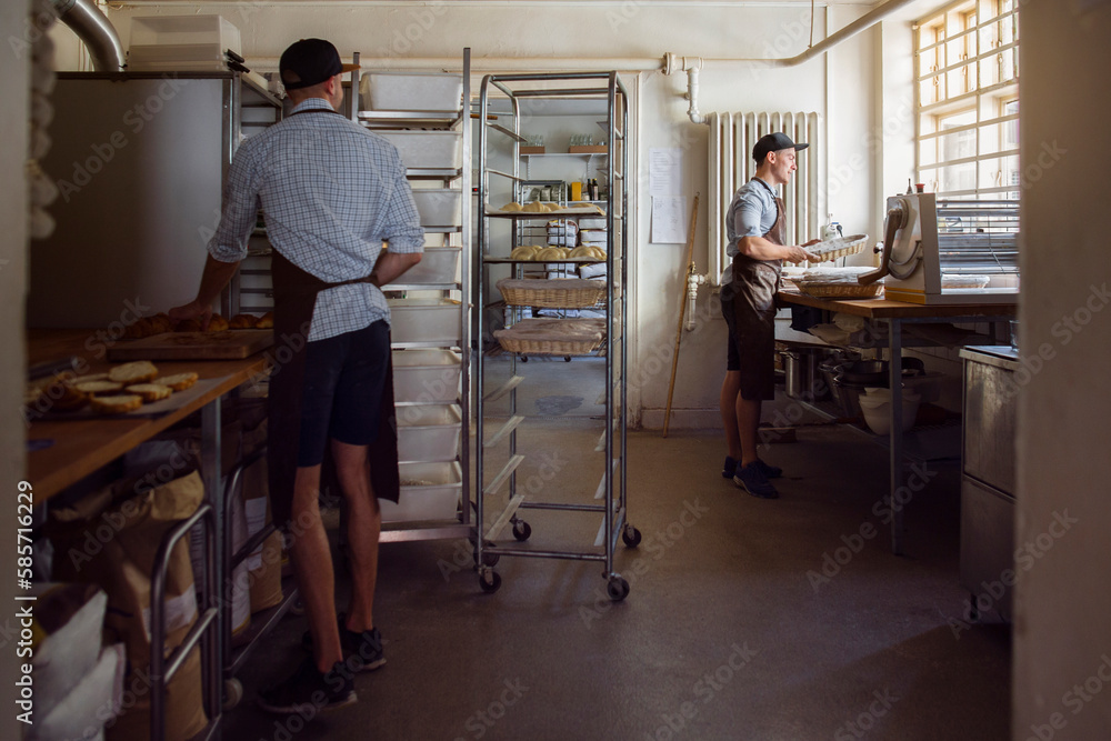 Bakers preparing dough in kitchen