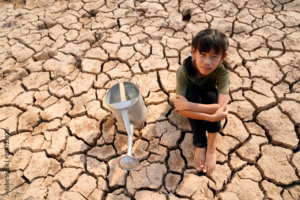 Sad kids are sitting on cracked earth open metal water old faucet on ...
