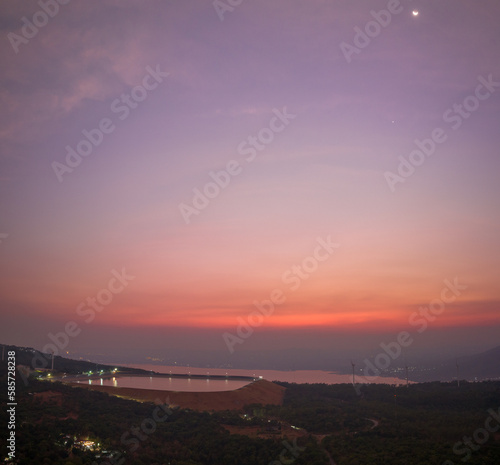 aerial view wind turbine viewpoint at Lamtakong dam,Nakhonratchasima, Thailand. amazing sky of sunset above Lamtakong dam beautiful reflection on the large pond. Gradient color. Sky texture, 