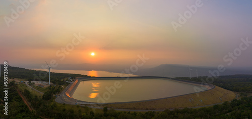 aerial view wind turbine viewpoint at Lamtakong dam,Nakhonratchasima, Thailand. amazing sky of sunset above Lamtakong dam beautiful reflection on the large pond. Gradient color. Sky texture, 