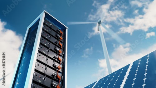 The video shows the energy storage system in lithium battery modules, complete with a solar panel and wind turbine in the background. 3d rendering. photo