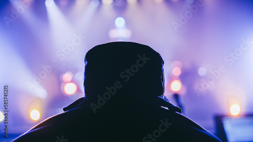 Man in front of stage spotlights
