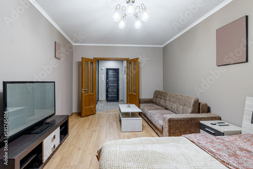 Gomtinaya in a small apartment with sofa  TV  large bed and coffee table