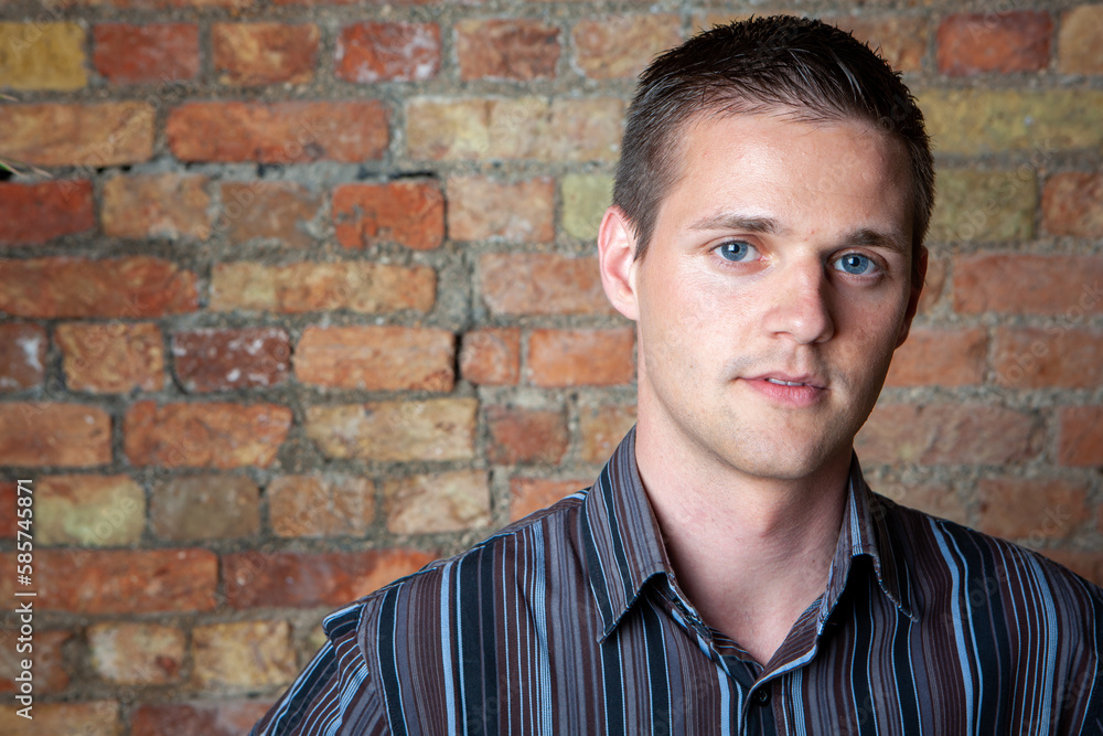 Blue Boy. A relaxed, neutral portrait of a handsome young man with eyes matching his blue striped shirt. From a series of related images. Blue Boy. A relaxed, neutral portrait of a handsome young man with eyes matching his blue striped shirt. From a series of related images.
