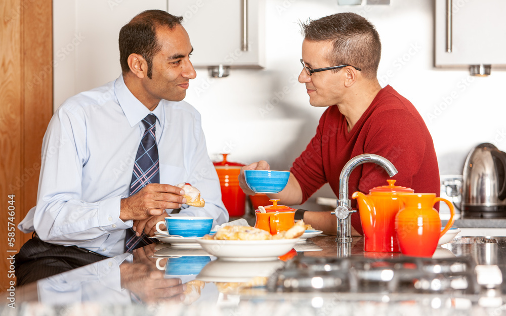 Gay Lifestyle: Breakfast Time. A same sex, mixed race male couple enjoying breakfast together in their modern home. From a series of related images. Gay Lifestyle: Breakfast Time. A same sex, mixed race male couple enjoying breakfast together in their modern home. From a series of related images.