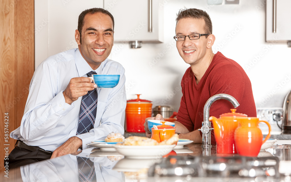 Gay Lifestyle: Good Morning. A same sex couple with bright smiles enjoying breakfast together in their modern home. From a series of related images. Gay Lifestyle: Good Morning. A same sex couple with bright smiles enjoying breakfast together in their modern home. From a series of related images.