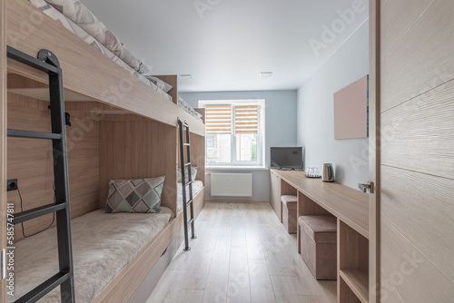 Fotografie Hostel dormitory beds arranged in dorm room with white plain bunk bed in dormitory