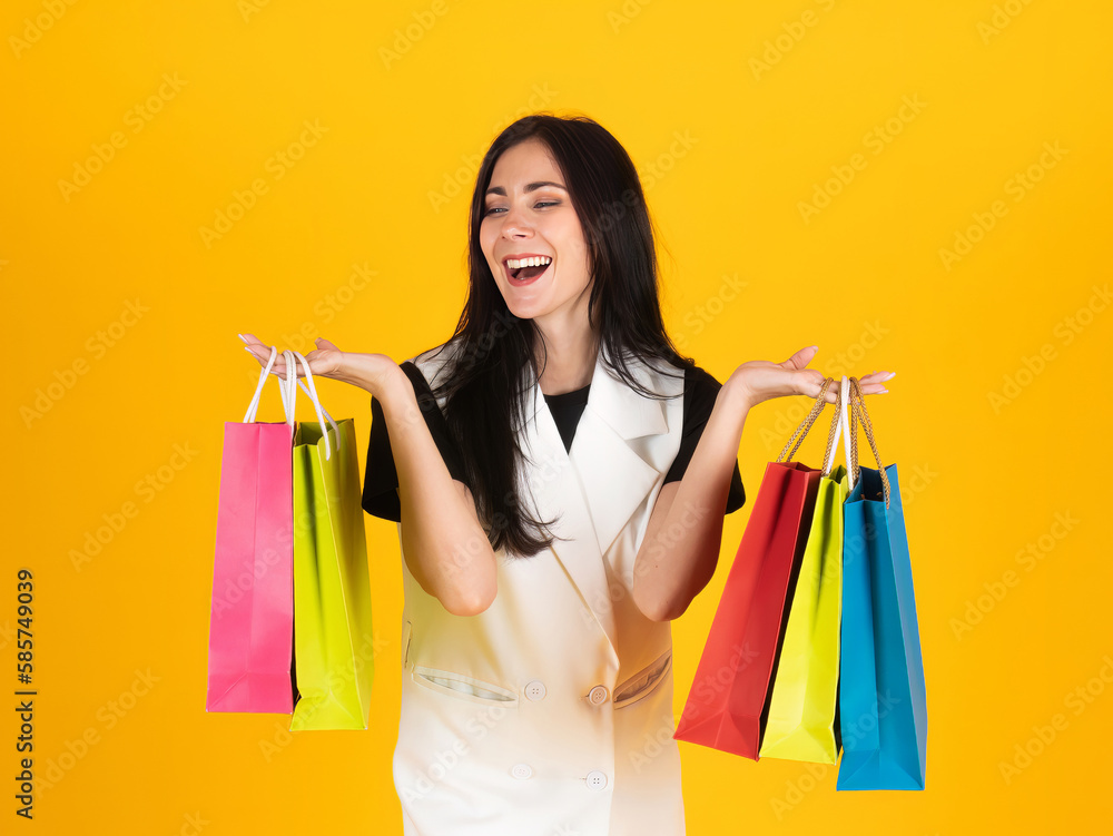 Cyber Monday Sale promotion event portrait isolated on yellow background of Caucasian shopper woman smile and enjoy when she buy beauty product and hold colorful paper bags Cyber Monday Sale promotion event portrait isolated on yellow background of Caucasian shopper woman smile and enjoy when she buy beauty product and hold colorful paper bags