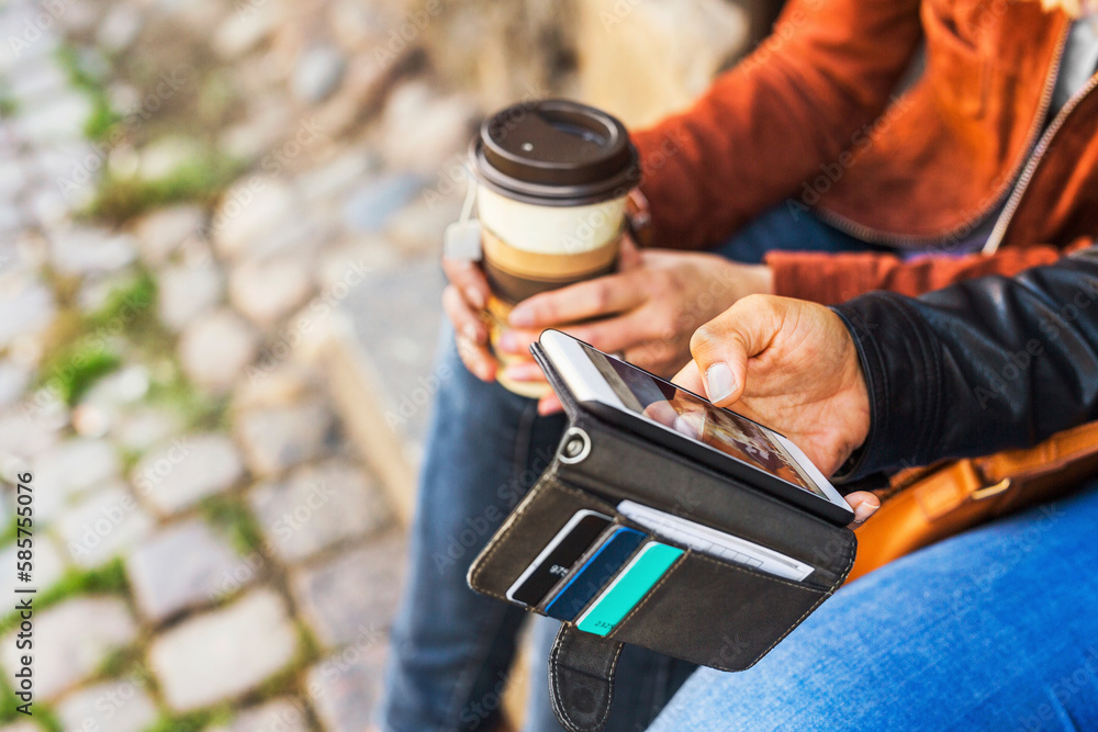 Women using smart phone and holding cup of coffee Women using smart phone and holding cup of coffee