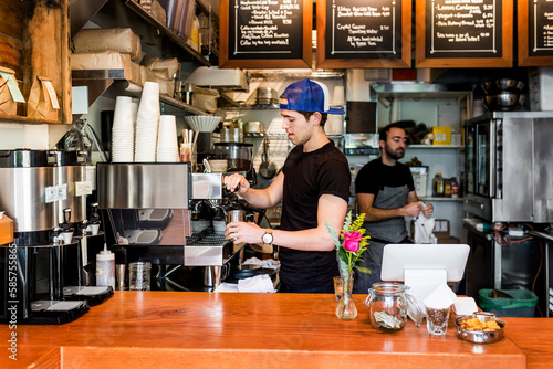 Two young men working in coffee shop