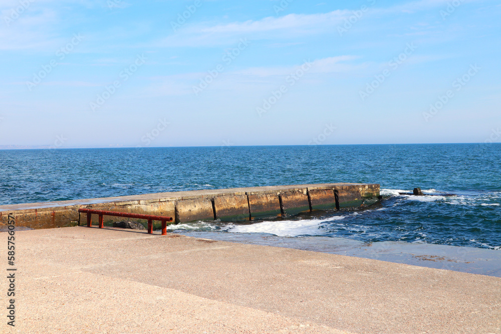 View of the embankment with a pier on a sunny day in Odessa, Ukraine
