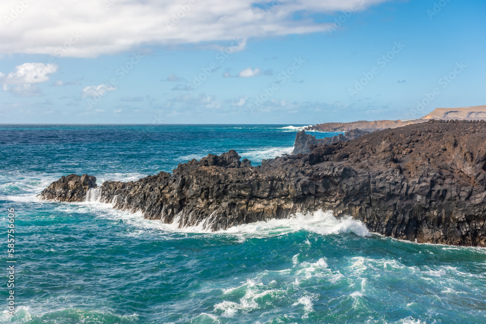Powerful waves of the Atlantic Ocean crashing on the volcanic cliffs of Los Hervideros in Lanzarote, Canary Islands, Spain Powerful waves of the Atlantic Ocean crashing on the volcanic cliffs of Los Hervideros in Lanzarote, Canary Islands, Spain