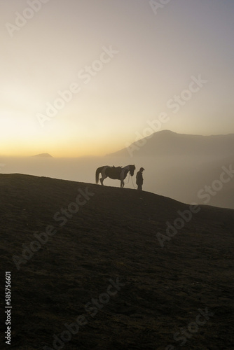 Man with horse in Mount Bromo, East java © Didik