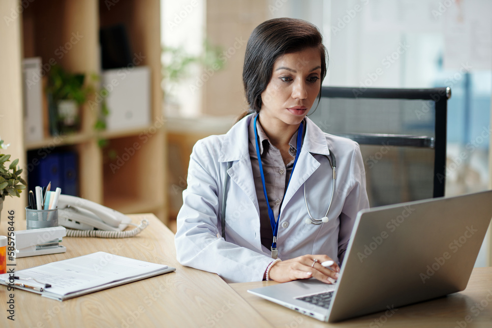 Manager of clininc answering e-mails from clients Manager of clininc answering e-mails from clients