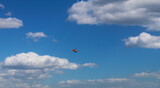 Helicopter in blue cloudy sky 