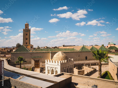 Sunlight, blue sky and clouds over the Ben Youssef Mosque in the Medina of Marrakech, Morocco, important muslim religious building with beautiful architecture