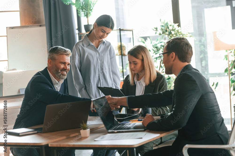 Having conversation, talking about plan. Group of business people are working in the modern office Having conversation, talking about plan. Group of business people are working in the modern office