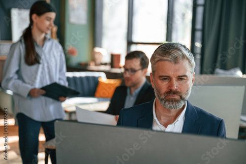 Using computer. Group of business people are working in the modern office