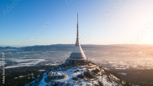 Jested mountain with modern hotel and TV transmitter on the top, Liberec, Czech Republic. Sunny winter day with snowy landscape. Aerial view from drone. photo